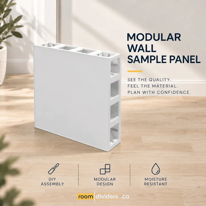 A white modular wall sample panel shown on a light wood floor in a styled room setting, with text reading 'MODULAR WALL SAMPLE PANEL' and feature callouts including DIY assembly, modular design, and moisture resistant.