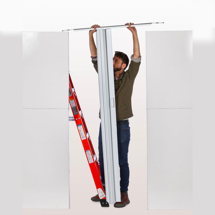 man installing accordion door on top of everpanel modular wall divider system